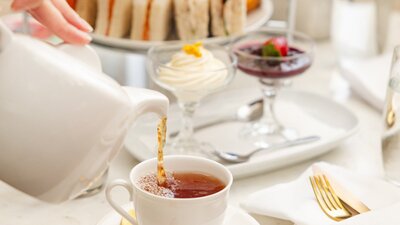 Pouring tea into cup