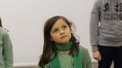 A young girl looks thoughtfully.