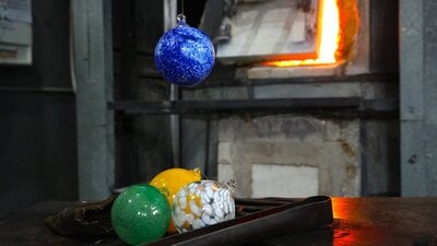 Glass baubles with glass blowing tools in the Hotshop