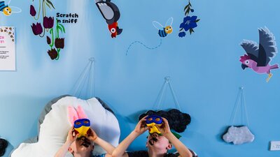 Two children participating in the scavenger hunt at Hop In