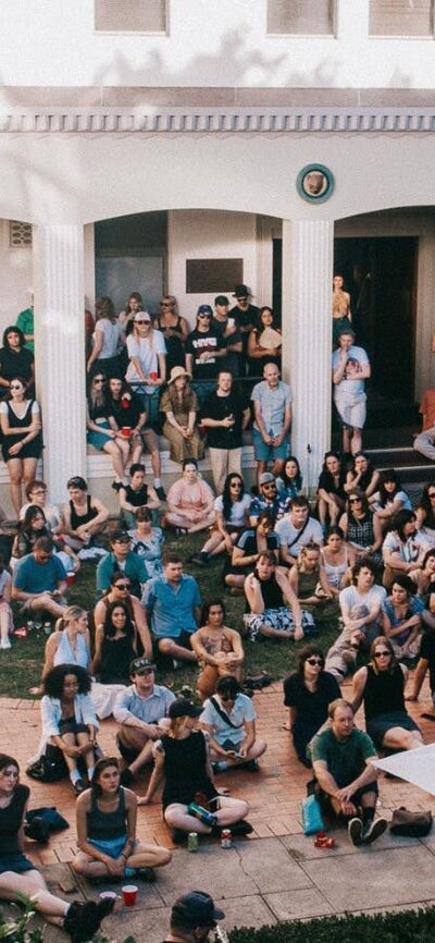 Image of people smiling and happy sitting in NFSA courtyard
