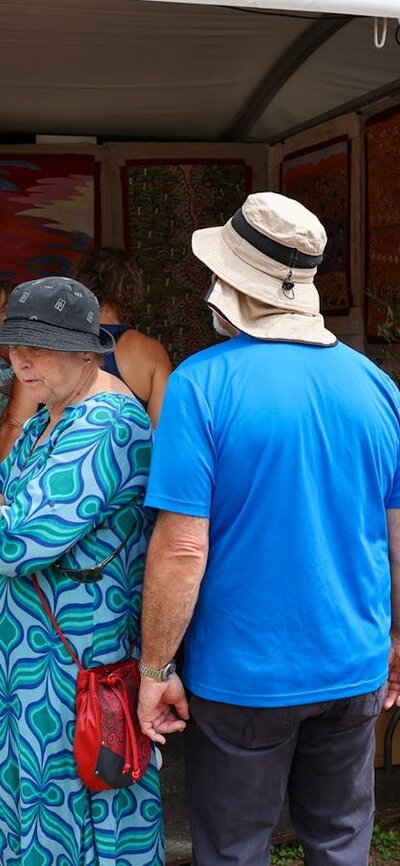 Buyers looking at artwork at the AIATSIS Indigenous Artwork