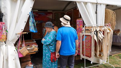 Buyers looking at artwork at the AIATSIS Indigenous Artwork