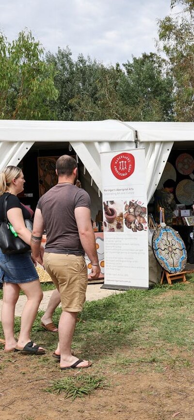 Buyers walking through the AIATSIS Indigenous Art Market