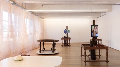 Contemporary art exhibition consist of sculptural objects which look like tables