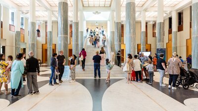Many people standing in the Marble Foyer of Parliament House