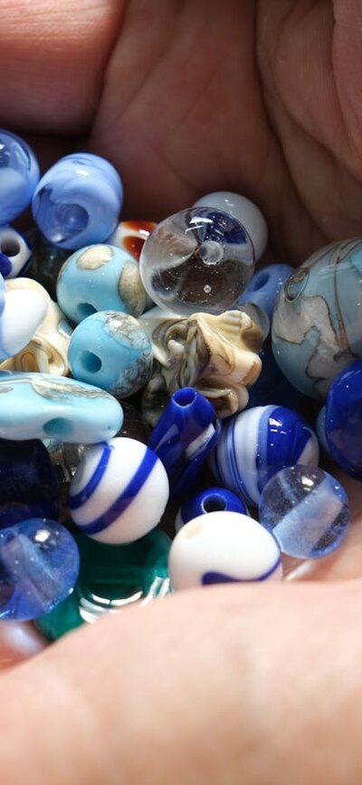 Handmade glass beads in hand