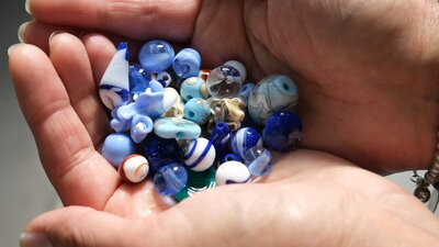 Intro to beadmaking at Canberra Glassworks Handmade glass beads in hand