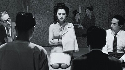 Black and white image of woman kneeling on floor with arms crossed