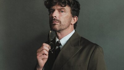 A close shot of a man holding glasses