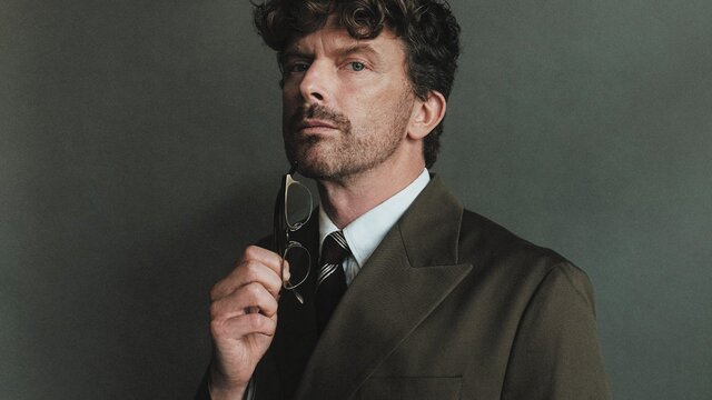 A close shot of a man holding glasses