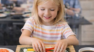 A girl making sushi