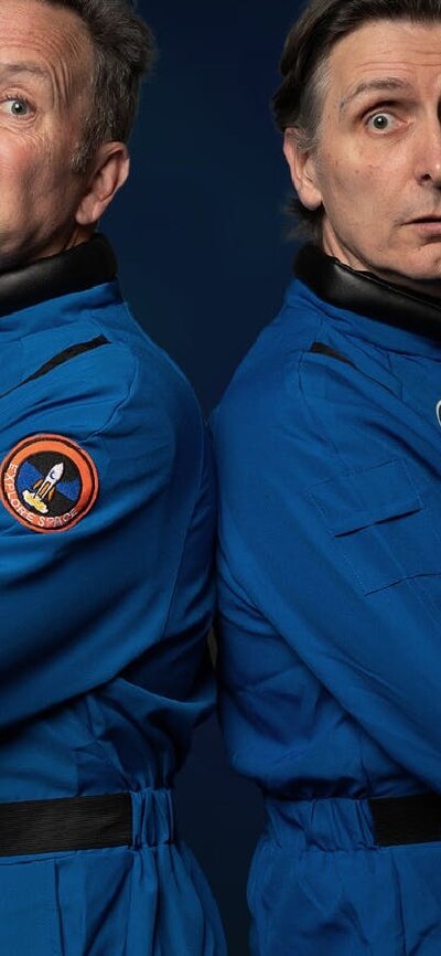Comedians Colin Lane and Frank Woodley standing back to back dressed as astronauts