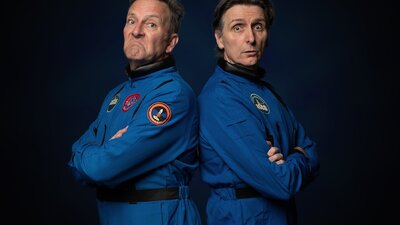 Comedians Colin Lane and Frank Woodley standing back to back dressed as astronauts