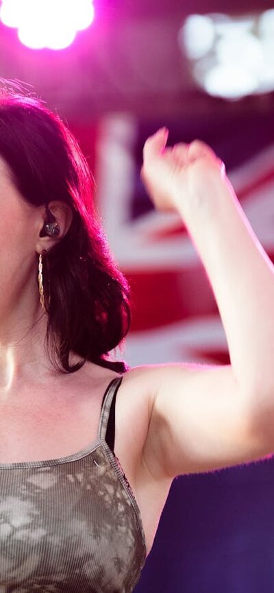 Female vocalist with Australian flag in background