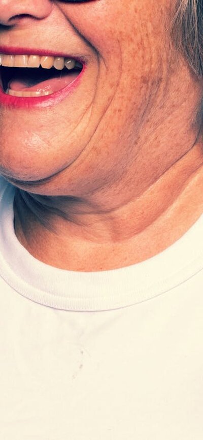 Woman wearing white top smiling