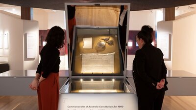 Two women viewing the Australian Constitution