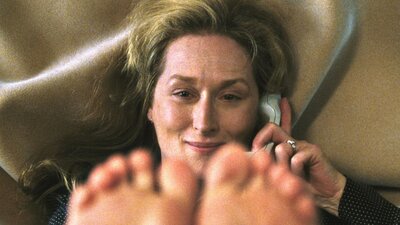 Adaptation (2002) Woman looks past camera, holding phone to ear with her feet in the air