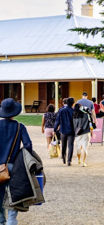 Live at Lanyon Concert attendees enter Lanyon Homestead with picnics in hand for Live at Lanyon