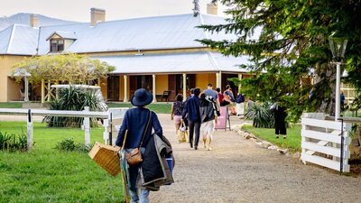 Concert attendees enter Lanyon Homestead with picnics in hand for Live at Lanyon