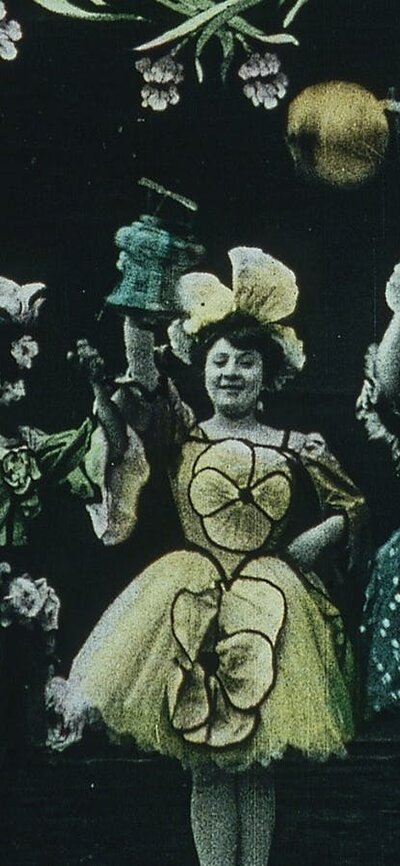 Vintage looking image of several women in a row dressed up in fancy dresses