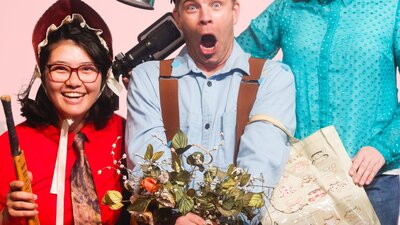 3 people holding garden items looking at something coming towards them with anticipation
