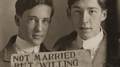'Not married but willing to be', Hugh Nini and Neal Treadwell collection. Two men holding a sign that reads 'NOT MARRIED BUT WILLING TO BE.'