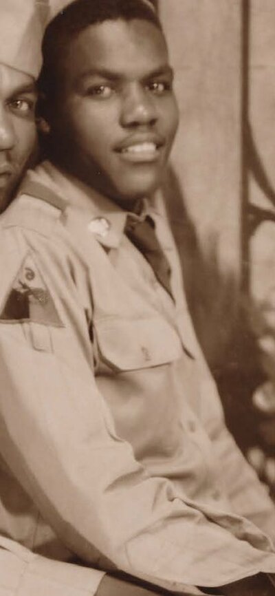 Archival image of two military men embracing in a pose looking at camera