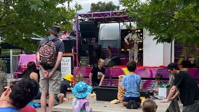 Kids and families watching a show outdoors