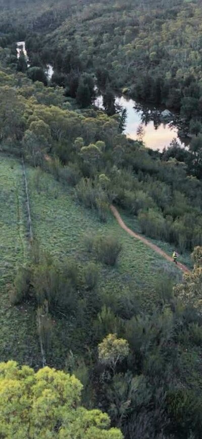 an arial photo of bushland and a river