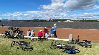 Dianne Firth gestures near the lake's edge as she explains the land axis from the Griffins' plan.