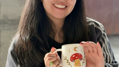 Guests holding their hand-painted ceramics at a NOA Matcha workshop