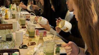 Group of guests at a long table during a NOA Matcha workshop