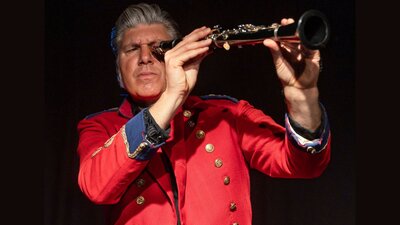 Mikelangelo holding up a clarinet as if using it as a telescope