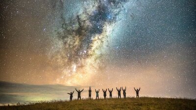 Astrophotographers posing under the Milky Way