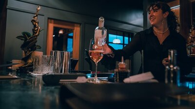 Bartender pouring glass of wine