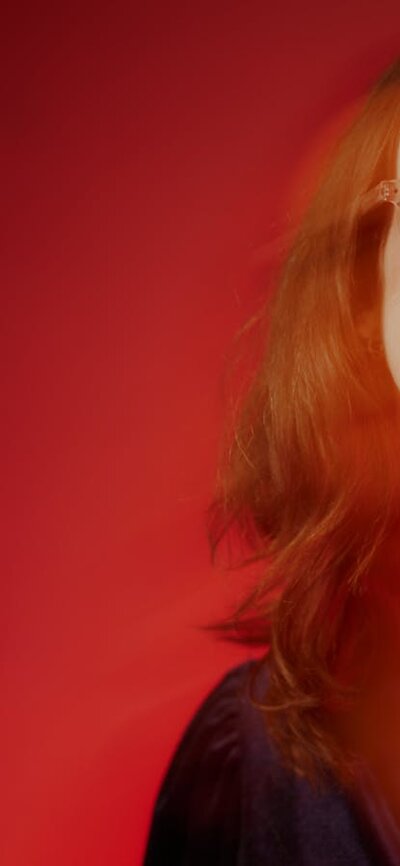 Woman against red background