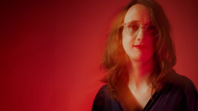 Woman against red background