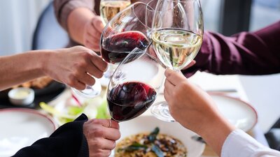 Mother's Day Lunch at Braddon Merchant Guests raising their wine glasses in a celebratory toast around a lunch table.