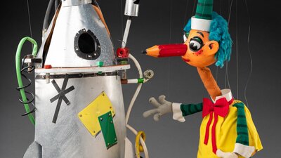 A puppet of a rocket ship and Mr Squiggle