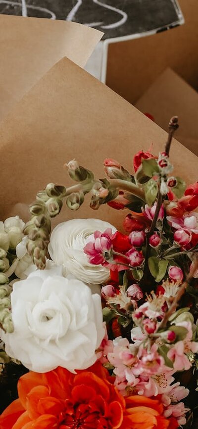 Mixed bunches of flowers wrapped up in brown paper