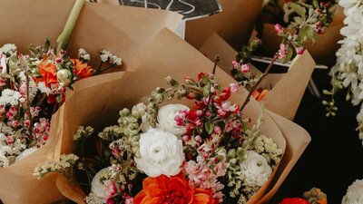 Mixed bunches of flowers wrapped up in brown paper