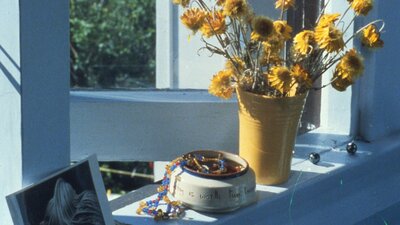 Photo of a windowsill with dry flowers and knick knacks