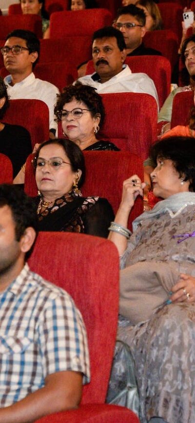 Audience seated inside the cinema