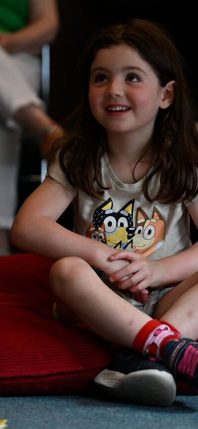 Child listening to a performance at Canberra Museum + Gallery