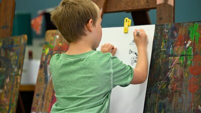 Child painting at Canberra Museum + Gallery