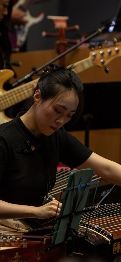 Member of ANU Chinese Classical Musical Ensemble performs on traditional Chinese instrument