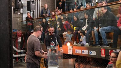 Visitors watching artists in the Hotshop