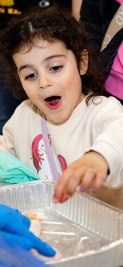 Excited about science A young girl shows excitement over a checmistry science experiment