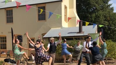 Dancers performing in front of old cream building